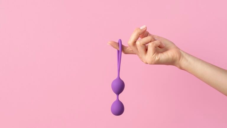 A hand holding anal beads