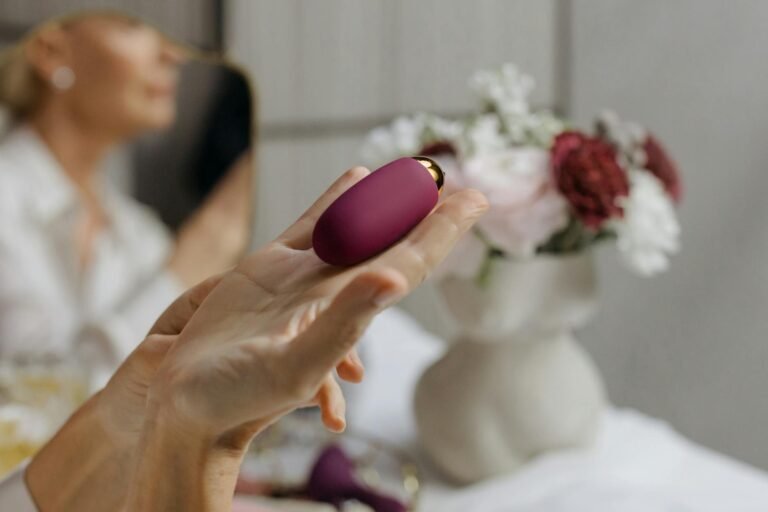 close up of woman holding a vibrator