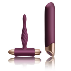 Two burgundy sex toys: a ribbed, curved vibrator standing upright and a smooth, bullet-shaped vibrator nearby on a white background with reflection.