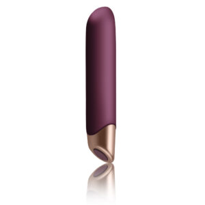 Purple vibrator with a rose-gold base standing upright, reflected on a white surface