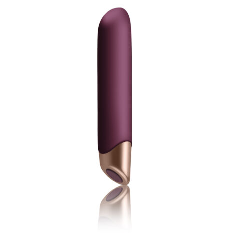 10SVTBAAZx2jpg Purple vibrator with a rose-gold base standing upright, reflected on a white surface