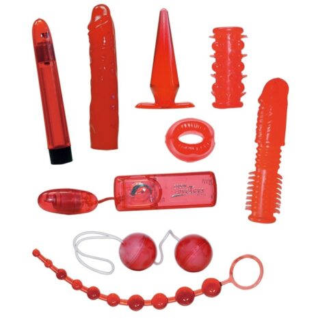 560936x1jpg Set of red sex toys laid out on a white background, including vibrators, plugs, rings, beads, and a chastity-style device.