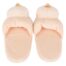 Soft peach-colored baby booties/slippers made of plush fabric with small top pom-poms, shown side by side