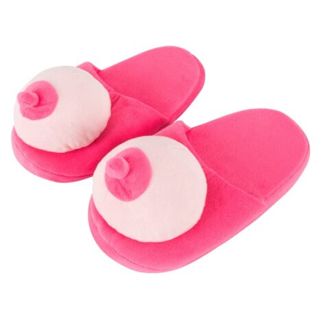 Pink plush slip-on slippers with large white circular decorations on the uppers, designed for indoor wear