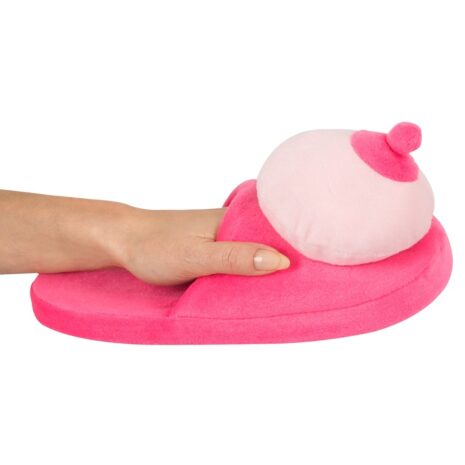 779830x4jpg Soft pink plush slipper being pressed by a hand, showing its cushioned, cozy material