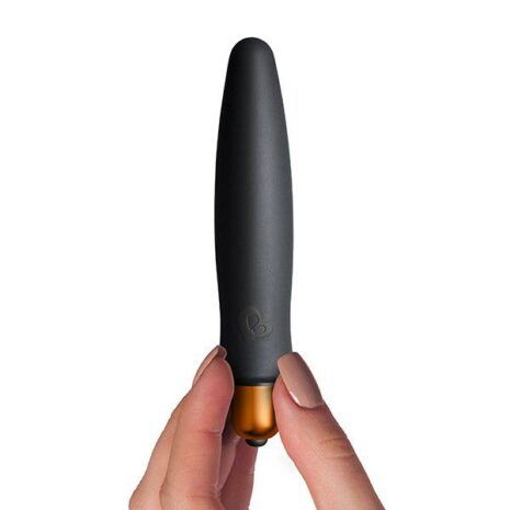 7SILSETx3jpg Black handheld vibrator with a copper base being held between two fingers against a white background.