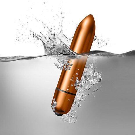 7SILSETx4jpg Orange cylindrical waterproof sex toy partially submerged in water, creating splashes.