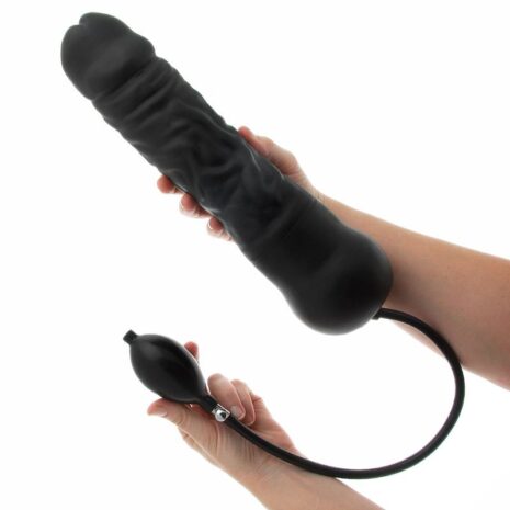 Black silicone dildo with a separate control remote, held by hands against a white background (adult sex toy).