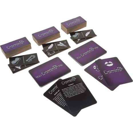 DOMIN8x2jpg Purple-backed card game set titled 'You Dominate Me' with instruction and action cards spread on a white surface.