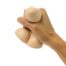 Hand tightly gripping three beige eggs against a white background
