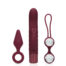 Set of three burgundy sex toys: a tapered silicone butt plug on the left, a large ribbed vibrator in the center, and a double-ball anal beads toy with a looped handle on the right.
