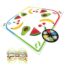 Fruit-themed Twister game mat with a spinner and colorful plastic rings beside it.
