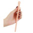 Hand holding a pink silicone dildo with a ridged shaft and rounded head against a white background.