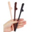 Hand holding three penis-shaped chocolate lollipops in peach, milk, and dark chocolate.