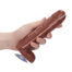 Hand gripping a brown adult dildo with a pink seam line and a suction cup base visible at the bottom left.