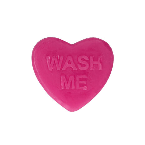 Pink heart-shaped soap bar with the words 'WASH ME' embossed on it.