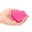 Hand holding a pink heart-shaped bar of soap with 'WASH ME' etched on it.