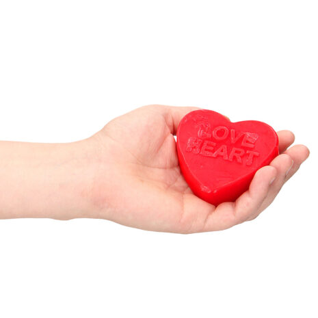 SLI199x2jpg Hand holding a red heart-shaped object with the words 'LOVE HEART' embossed on it.