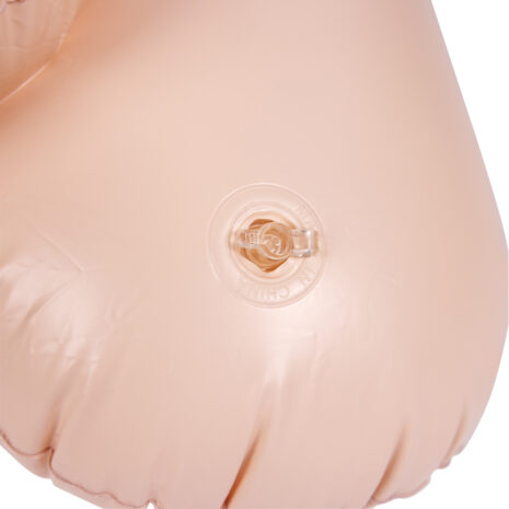 SLI234FLEx3jpg Close-up of a circular clear inflation valve embedded in a peach-colored silicone surface (likely on a medical training mannequin).
