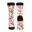 Pair of white knee-high socks with rainbow hearts and striped triangle patterns; black toes and cuffs, one heel has a hole edge showing.